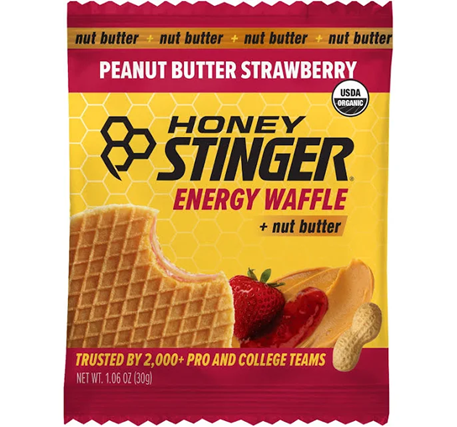 Honey Stinger Peanut Butter Strawberry Energy Waffle packaging with a yellow and red design.