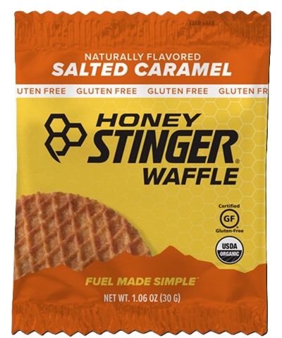 Honey Stinger waffle package with salted caramel flavor on an orange and yellow background